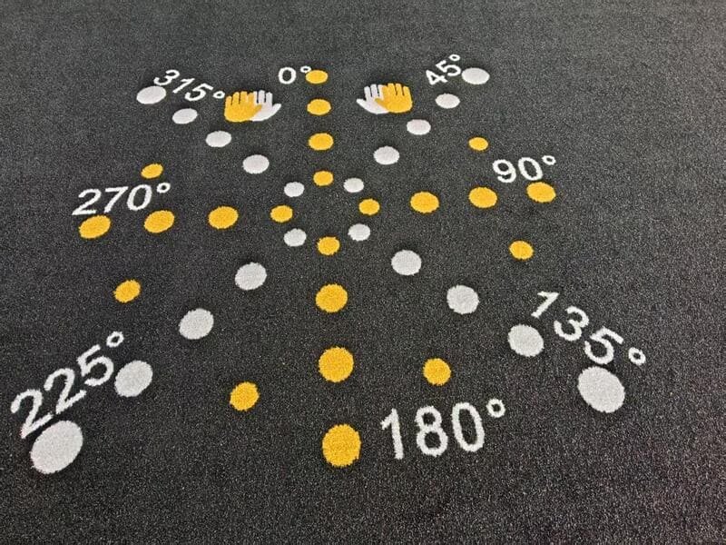 Staff member cleaning gym turf with professional equipment